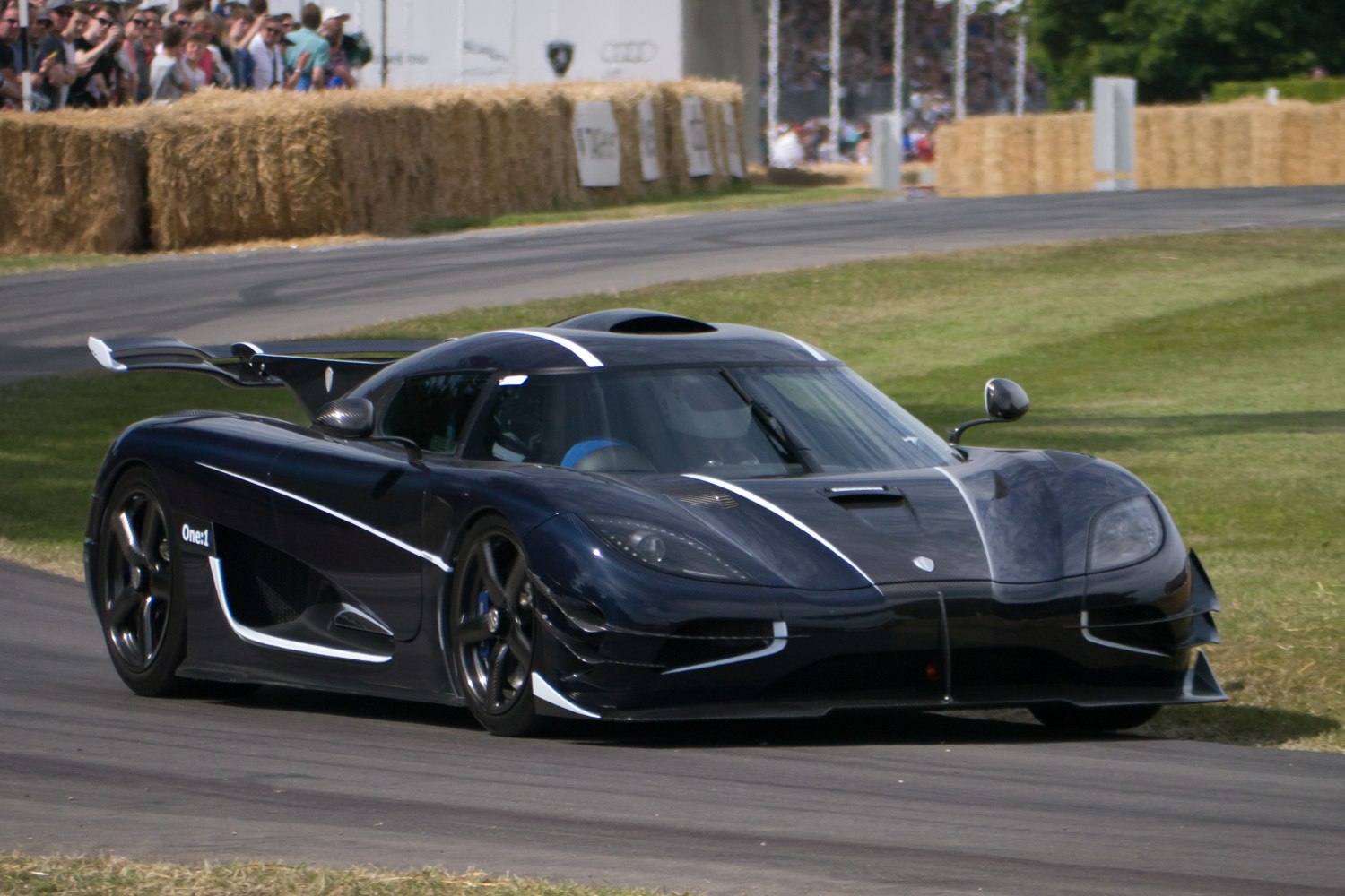Black hypercar with aerodynamic styling and large rear wing
