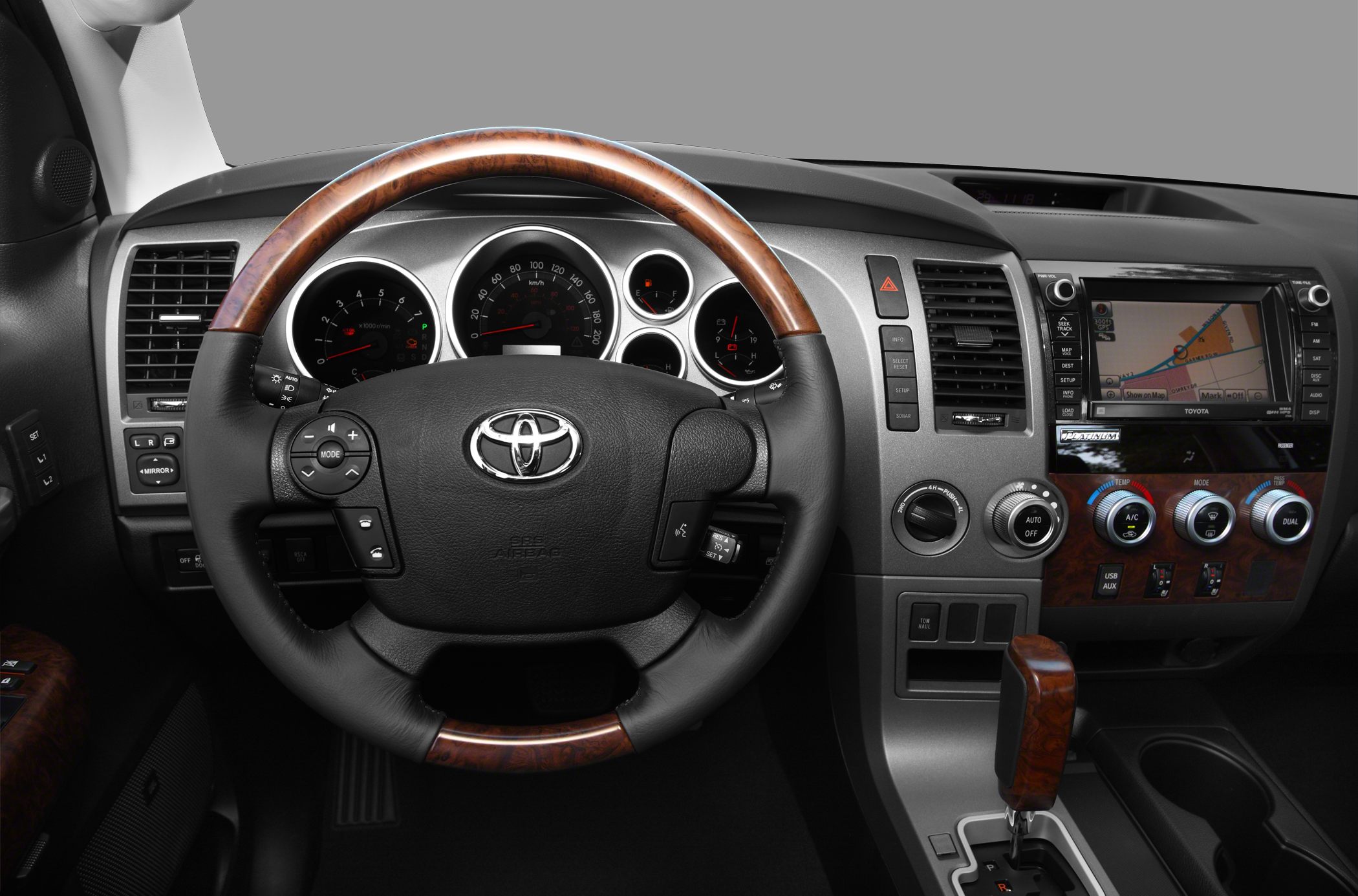 Steering wheel and dashboard with wood accents and navigation system