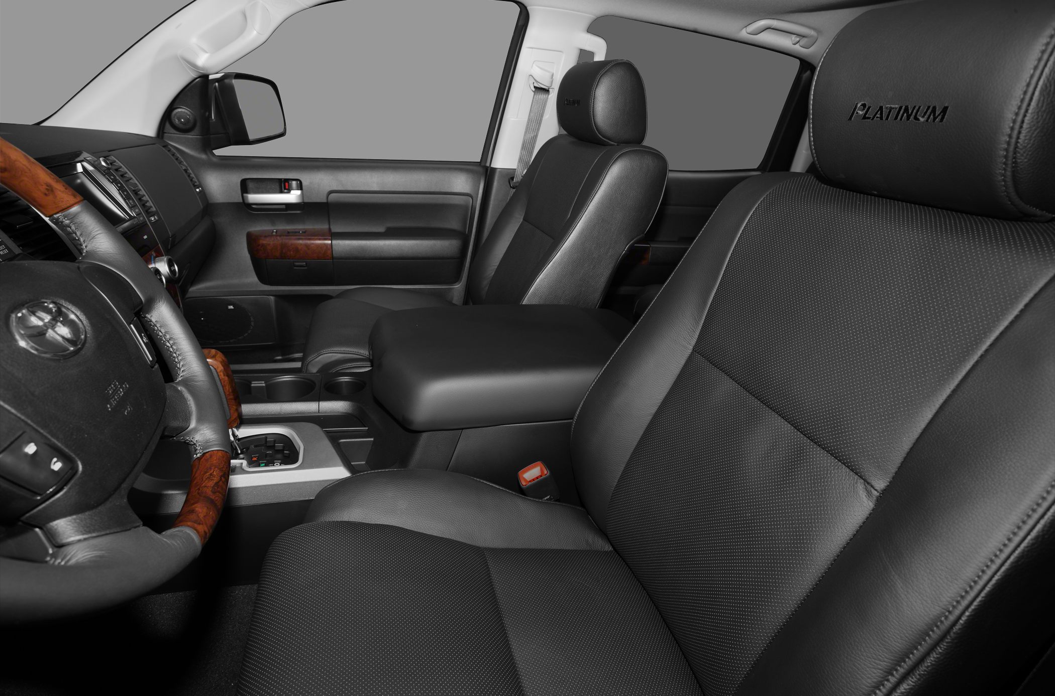 Leather seats and wood trim interior with steering wheel and dashboard