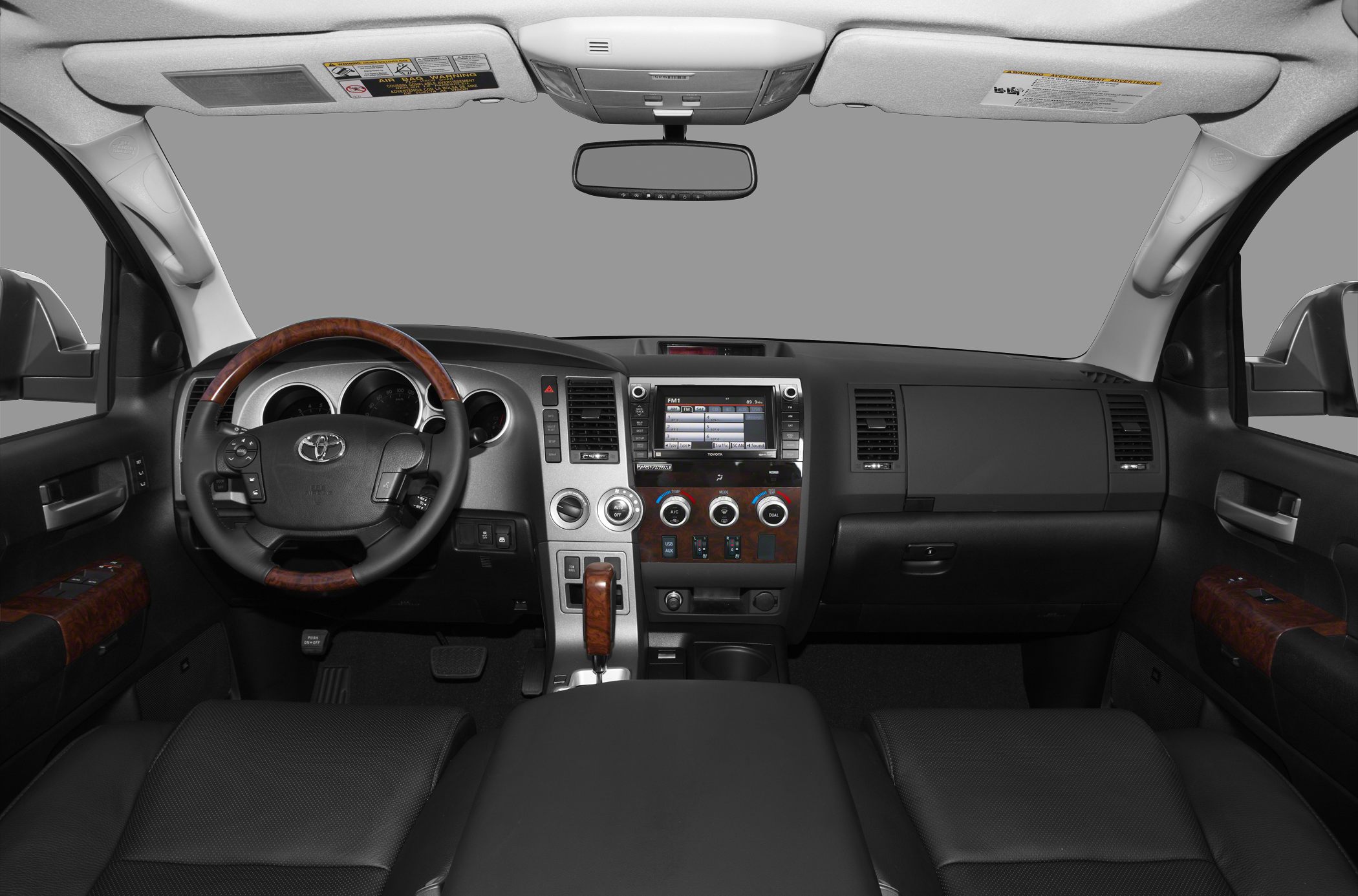 Interior dashboard with wood-trimmed steering wheel and infotainment system