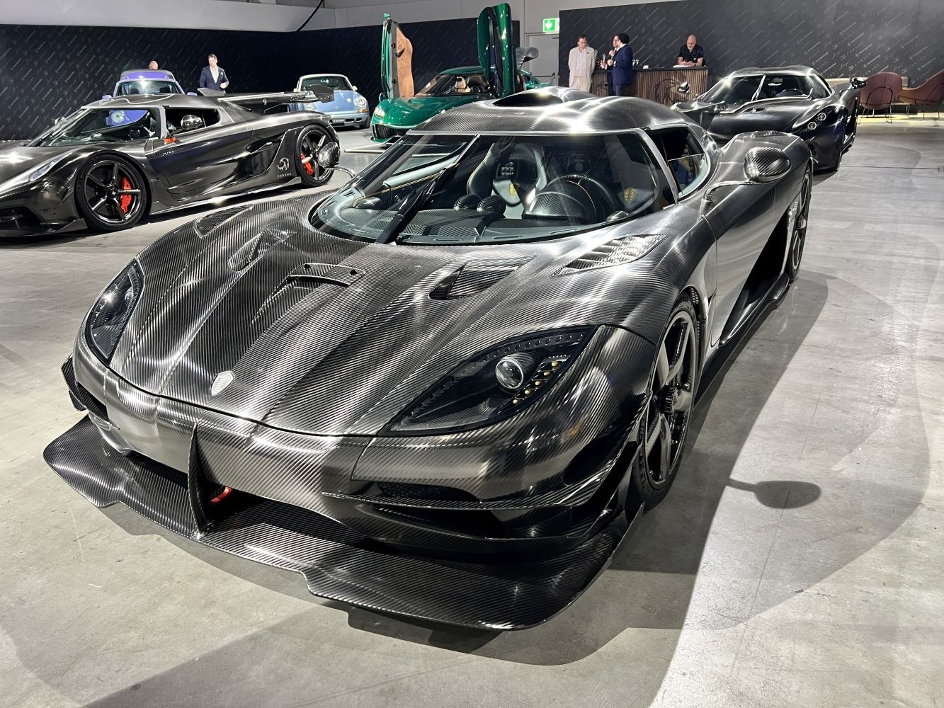 Carbon fiber supercar with aerodynamic front splitter and vented hood