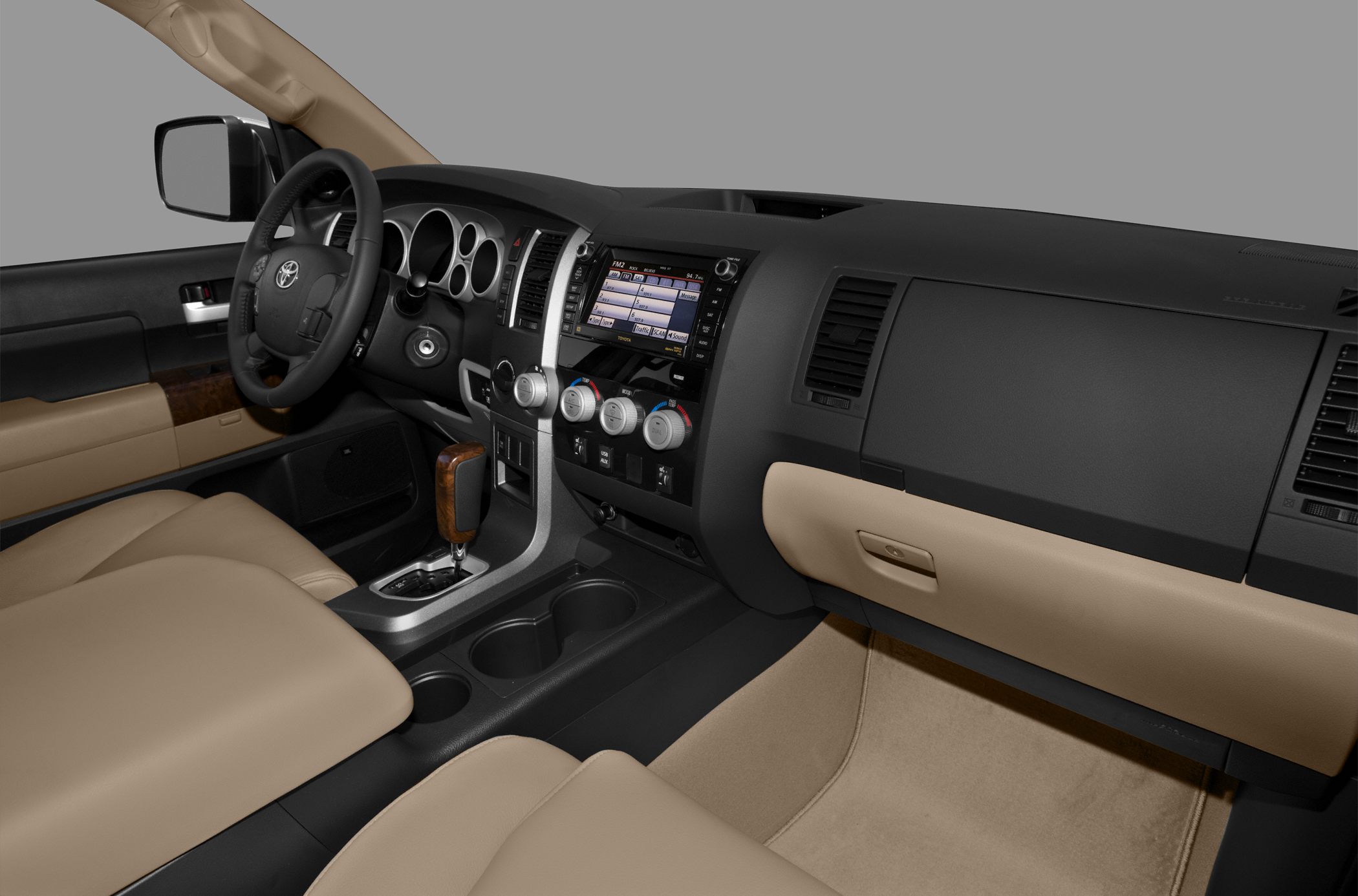 Beige leather seats, touchscreen infotainment and wooden gear shift knob