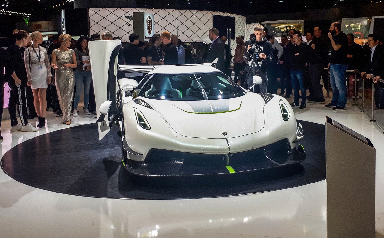 Front view of a high-performance sports car with butterfly doors open