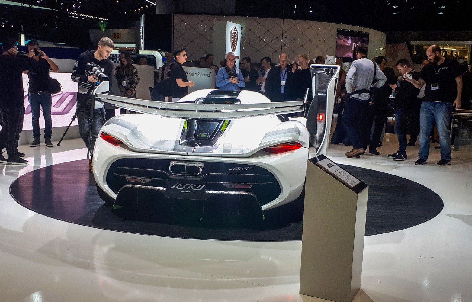 Rear view of white supercar with large rear wing and aerodynamic diffuser