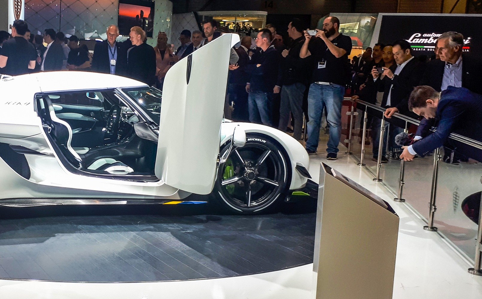 Upward-opening dihedral doors and visible sporty interior