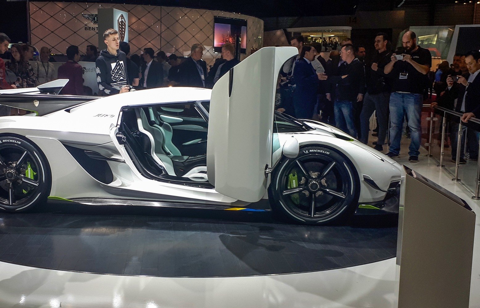 Butterfly door open with visible racing seats and aerodynamic sports car design
