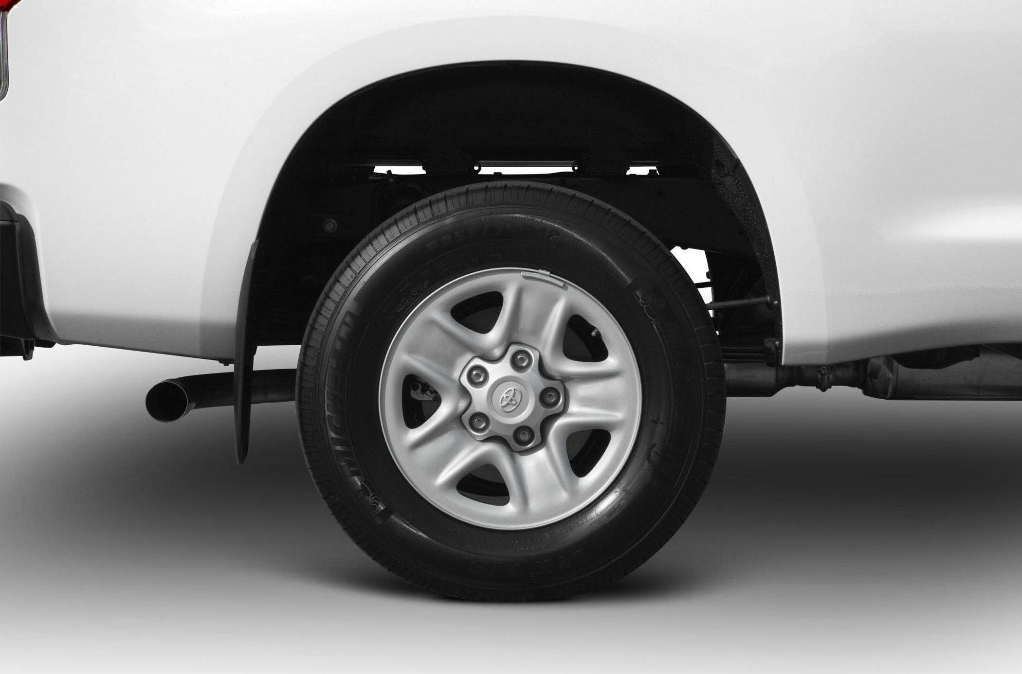Close-up of updated wheel and tire on pickup truck rear.