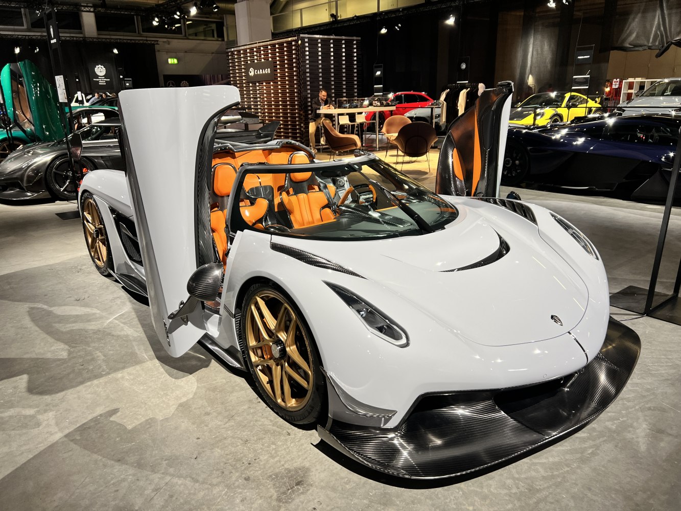 Sports car with dihedral doors and carbon fiber front splitter.