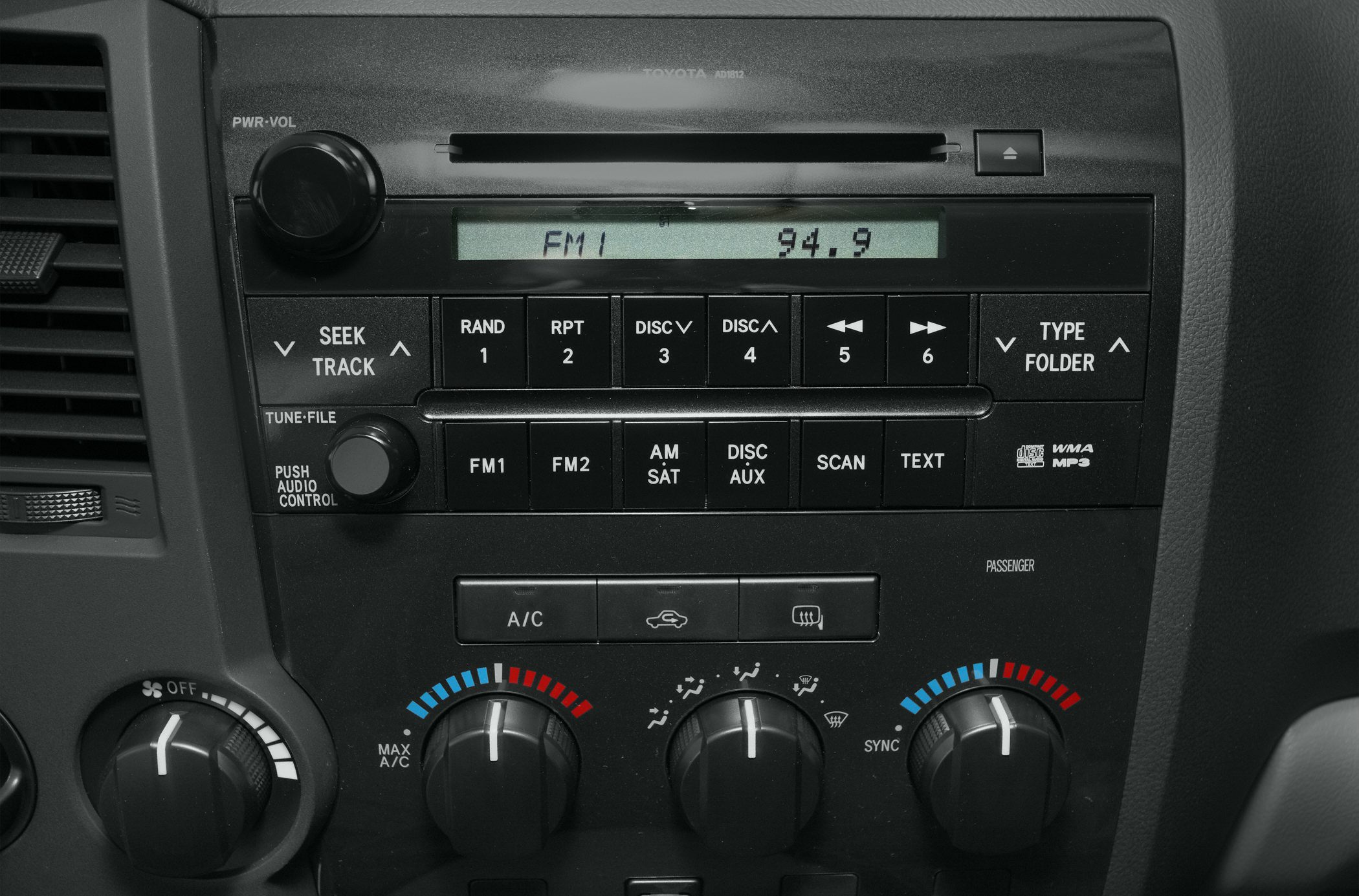 Close-up of audio system and climate control knobs