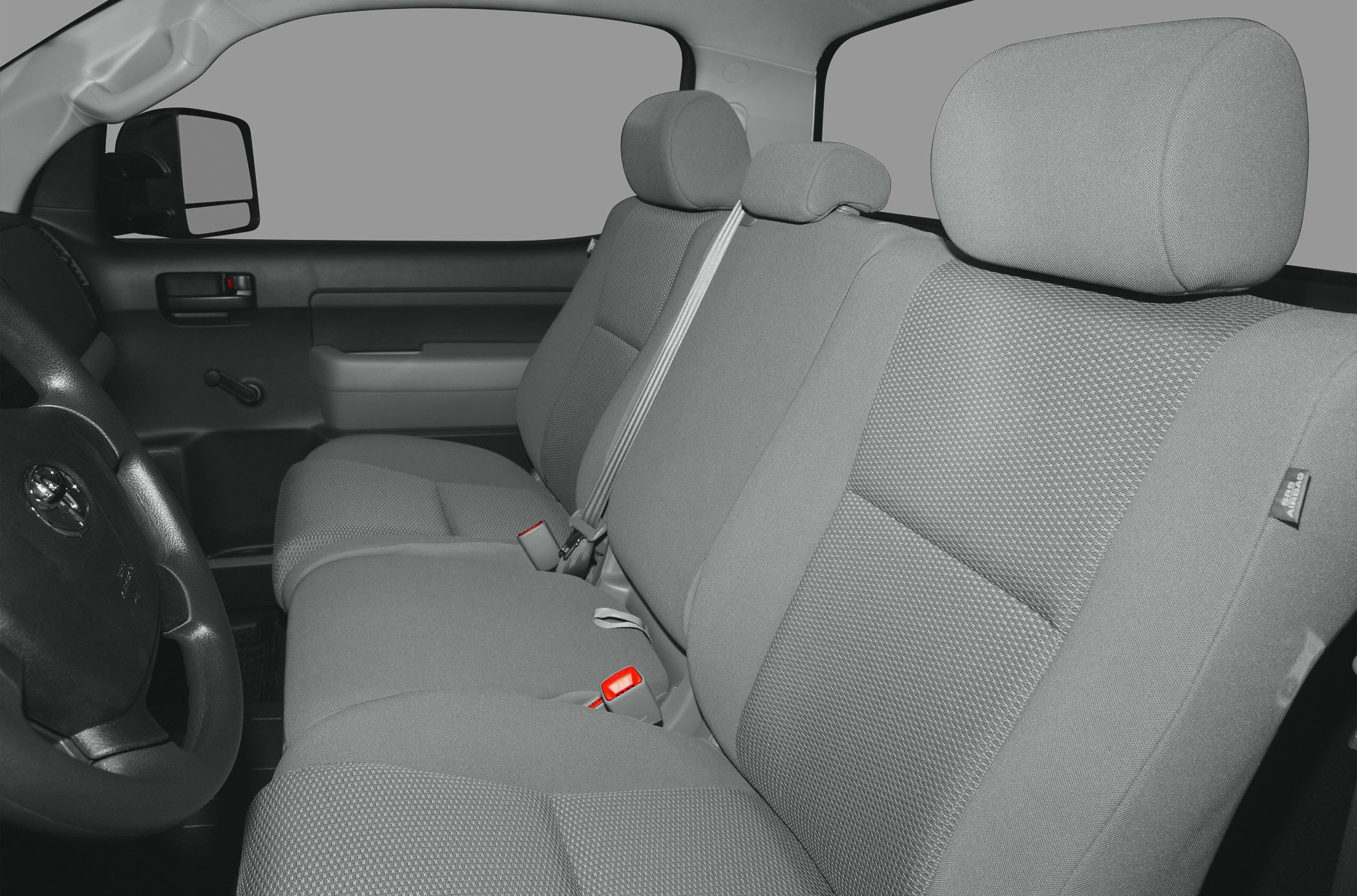 Bench seat interior with headrests and fabric upholstery in truck cabin