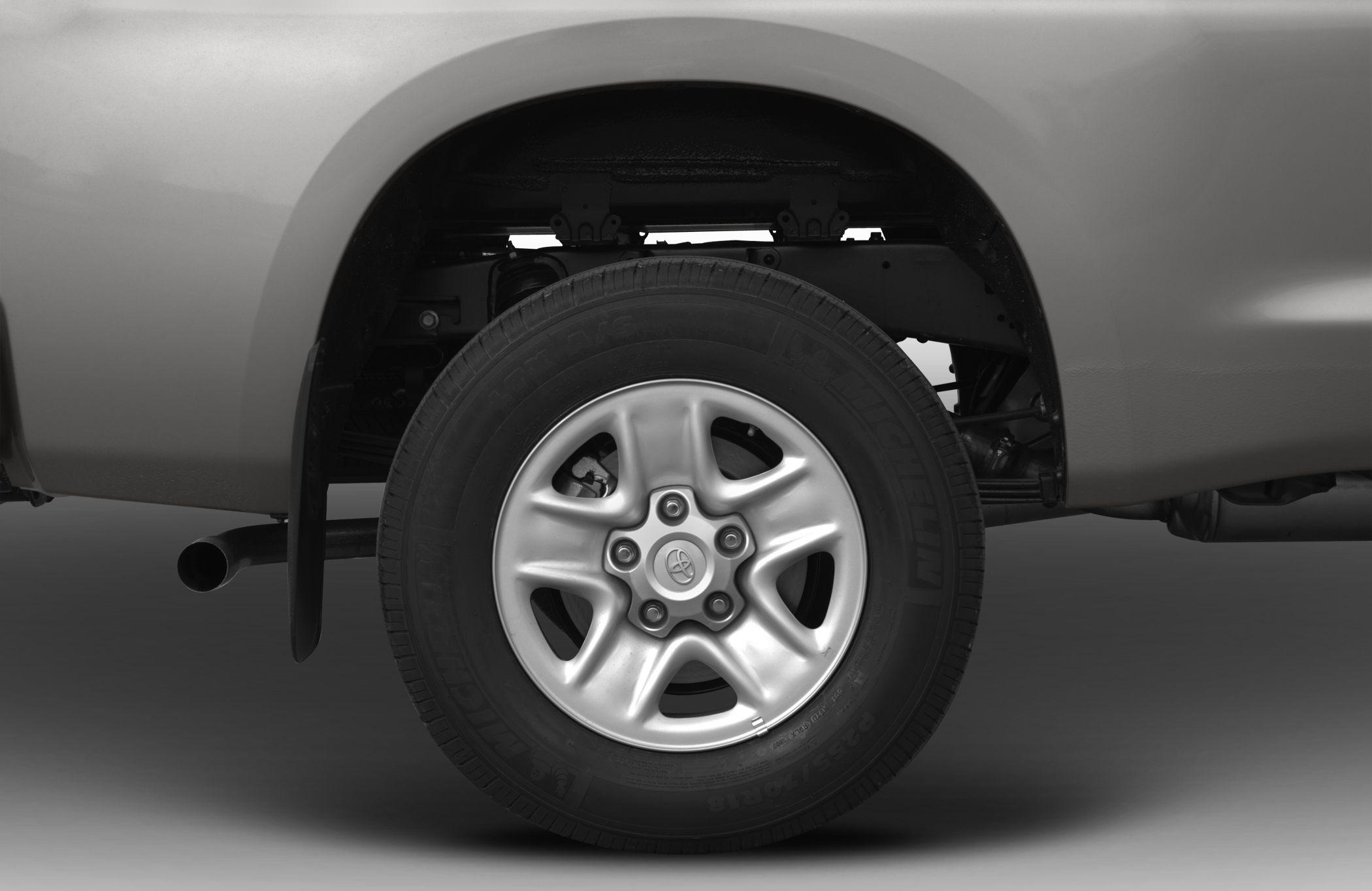 Close-up of alloy wheel and rear suspension of pickup truck