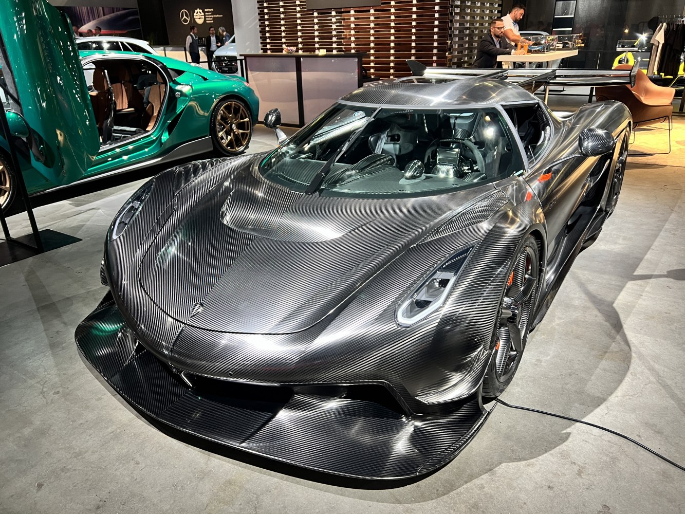 Exposed carbon fiber body and aerodynamic front design of a supercar.