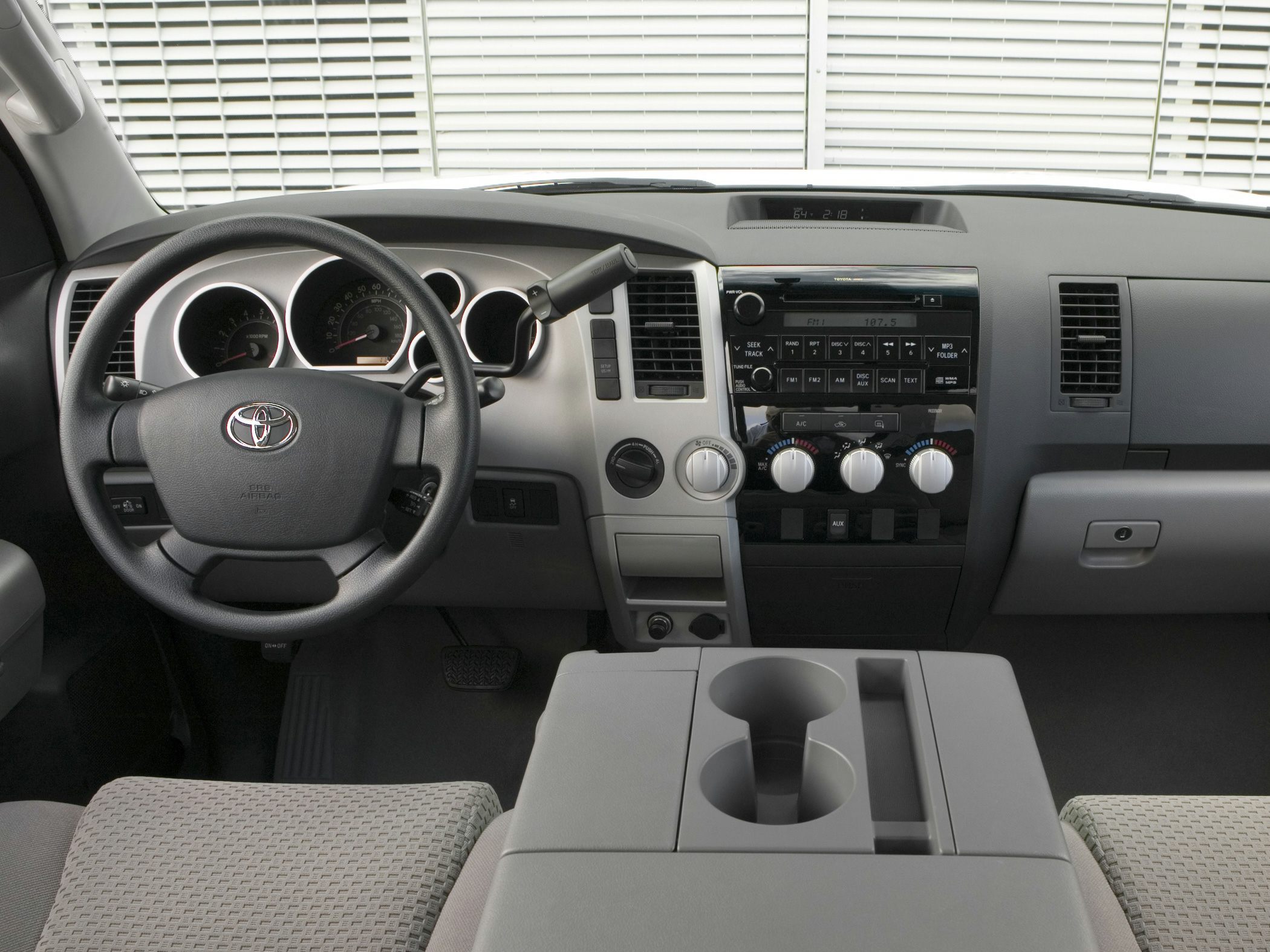 Dashboard, steering wheel, and center console with cup holders