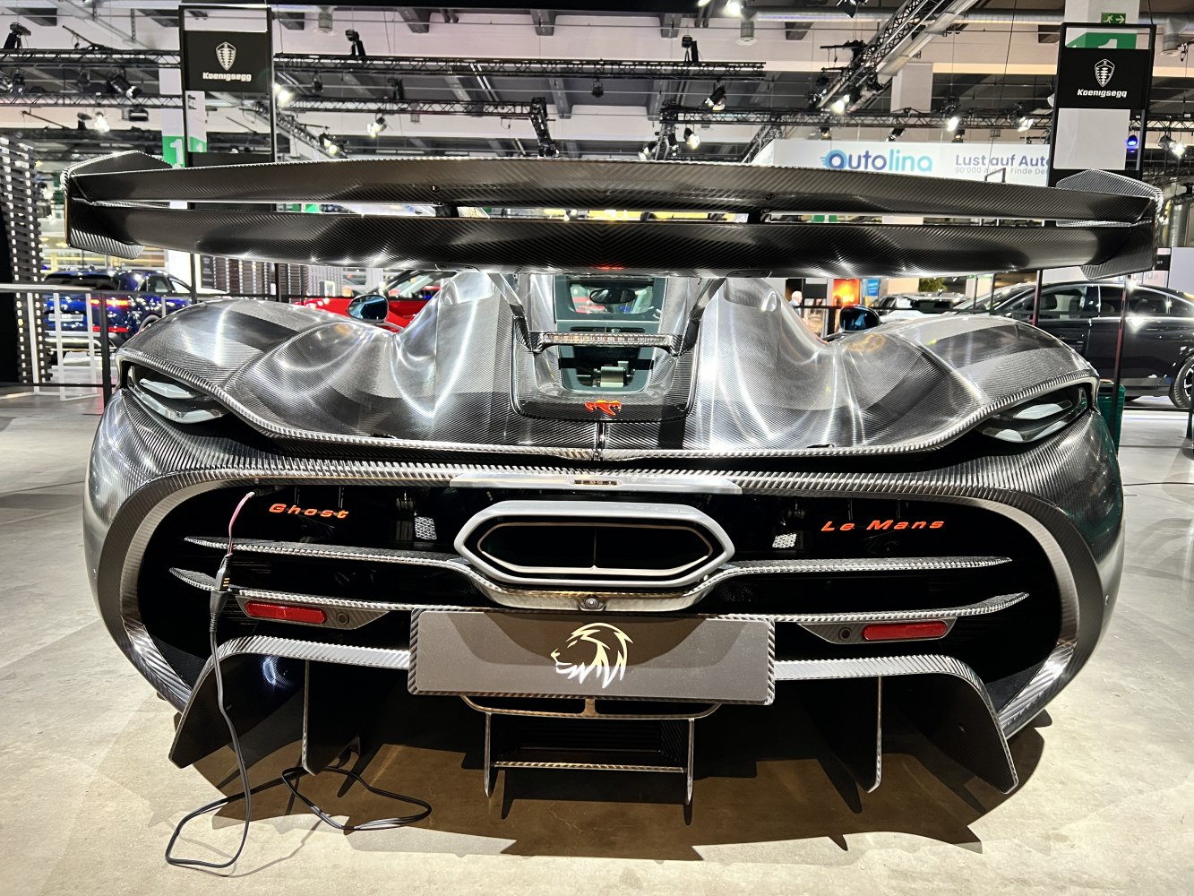 Rear view with large carbon fiber wing and aerodynamic diffuser