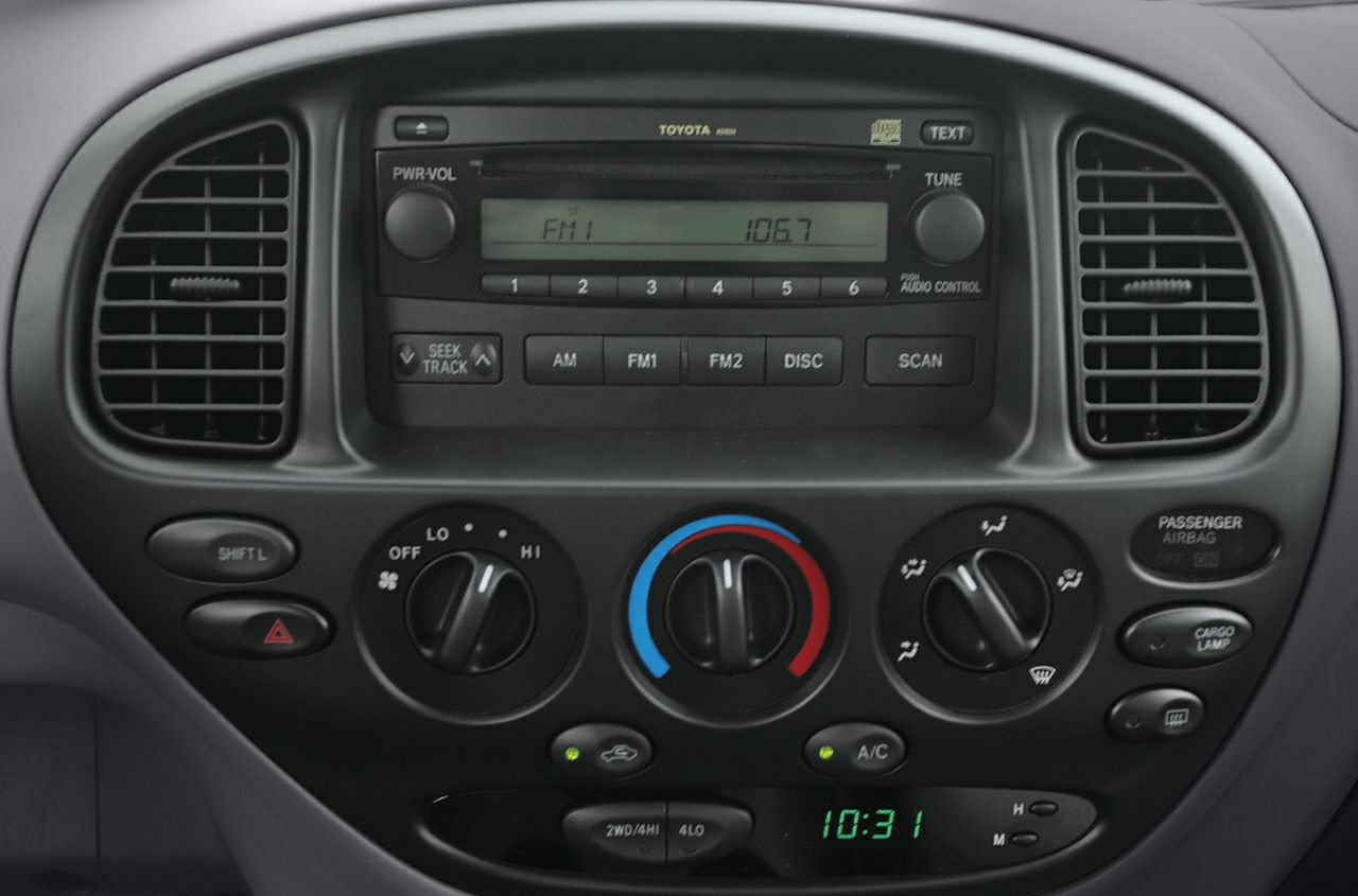 Center console with radio, climate control knobs, air vents, and digital clock
