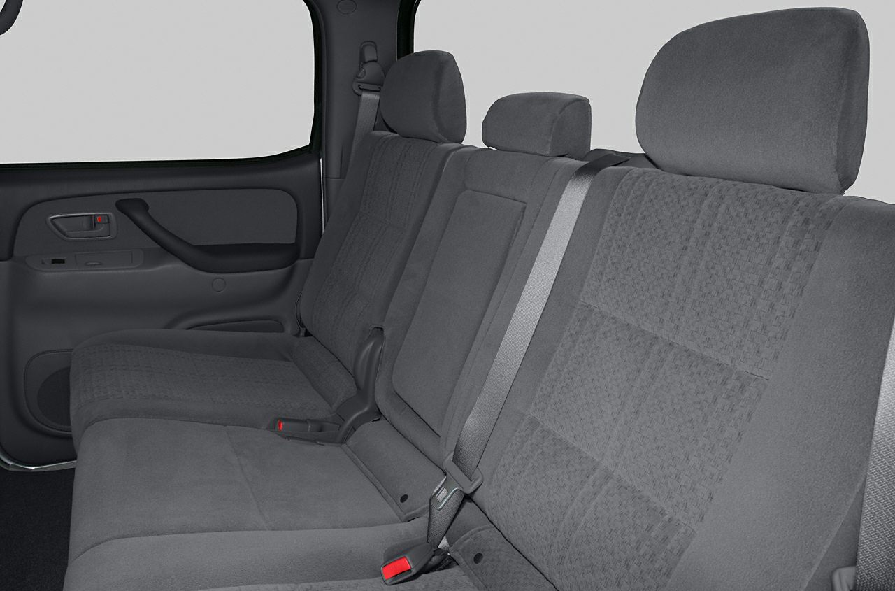 Rear seat interior with fabric upholstery and seat belts.