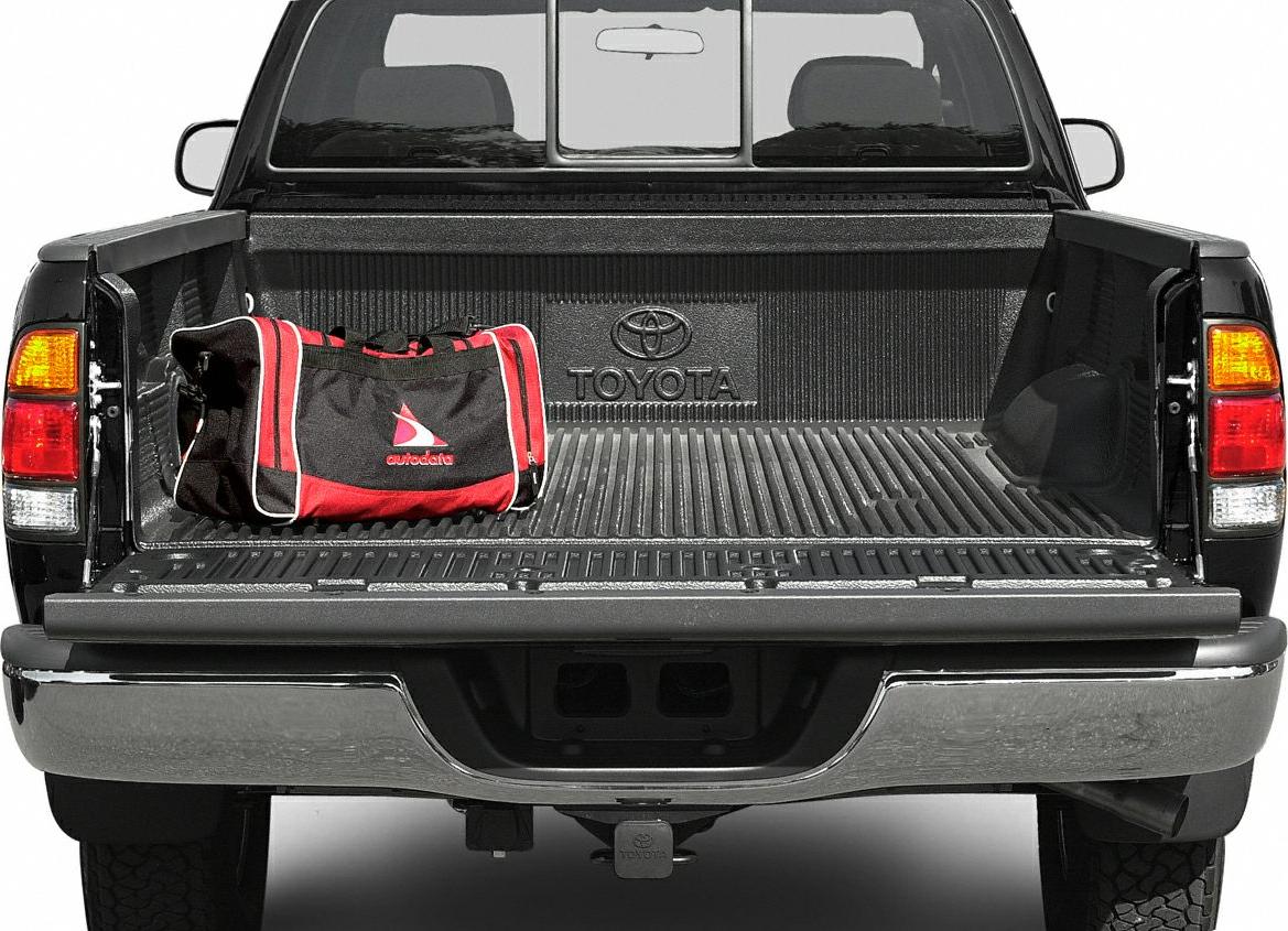 Open pickup truck bed with protective liner and tool bag on tailgate