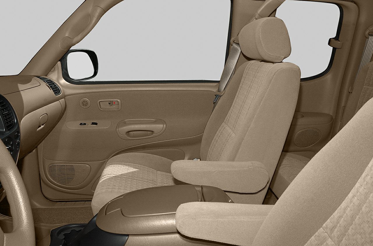Beige interior upholstery with front seat, armrest, and door panel view
