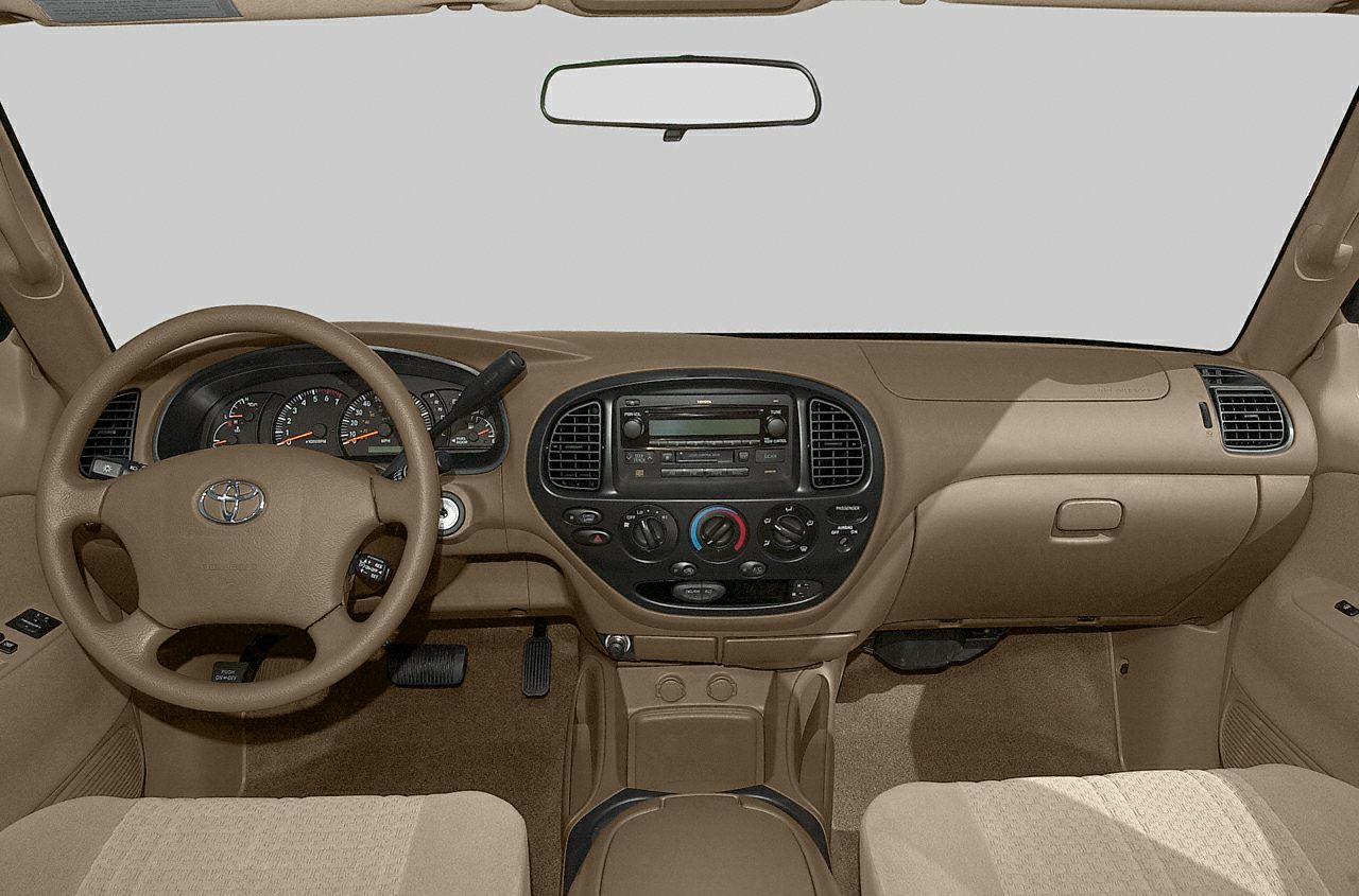 Dashboard and steering wheel inside truck cabin with control panels