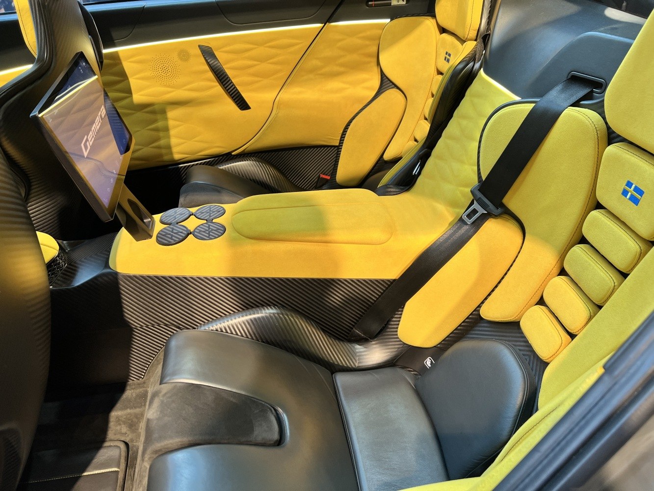 Luxury interior with yellow upholstery and carbon fiber detailing