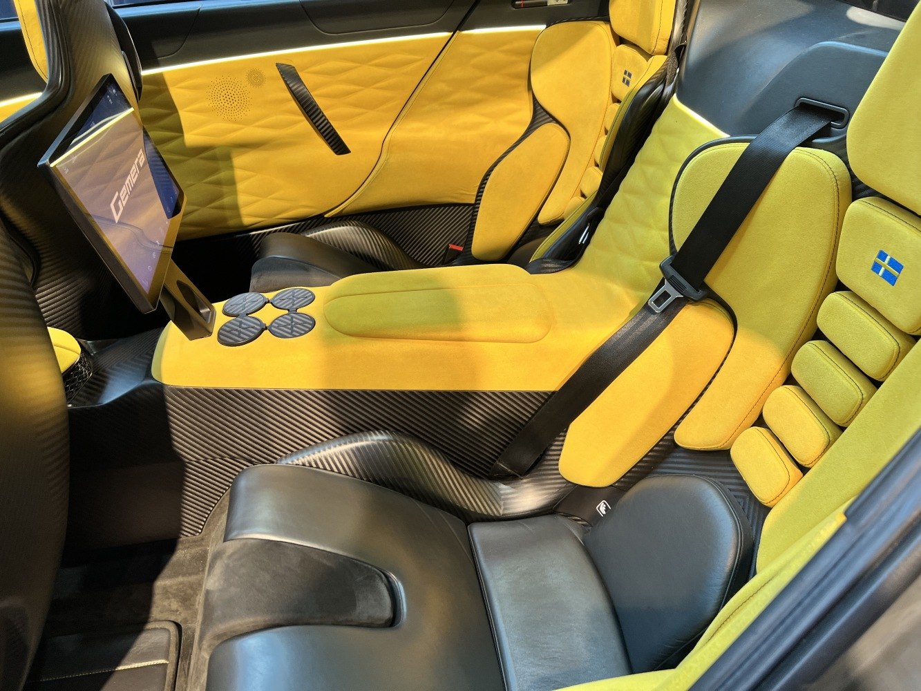 Yellow luxury seats with carbon fiber accents and digital display