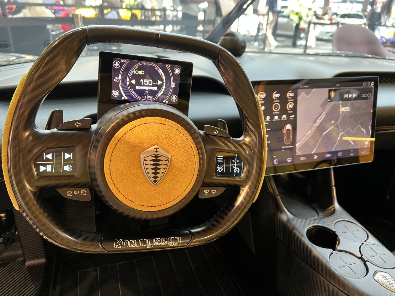 Carbon fiber steering wheel with digital instrument cluster and large infotainment screen