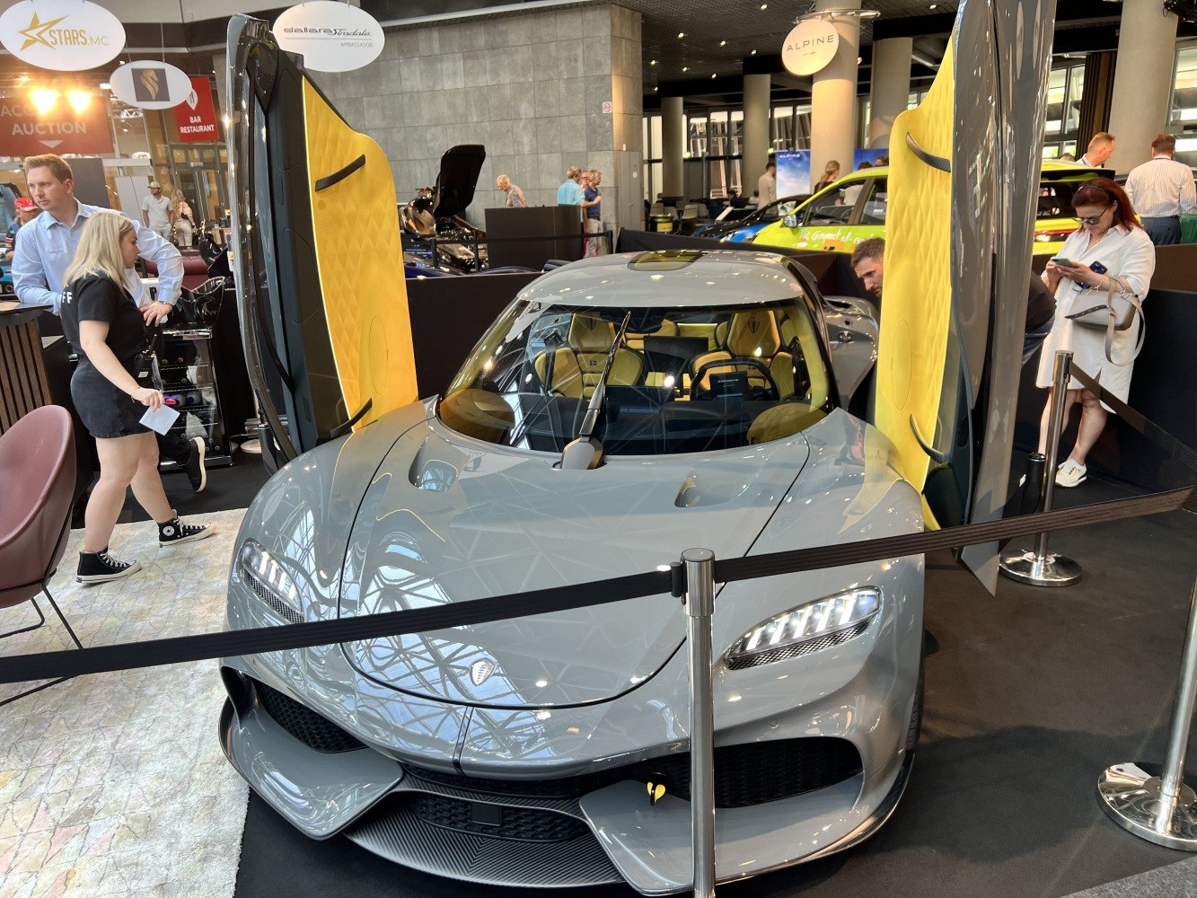 Gray Koenigsegg Gemera with butterfly doors and yellow interior