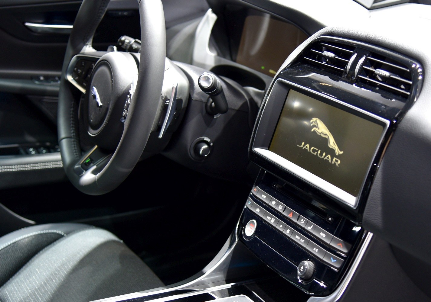 Jaguar car interior with steering wheel and infotainment dashboard