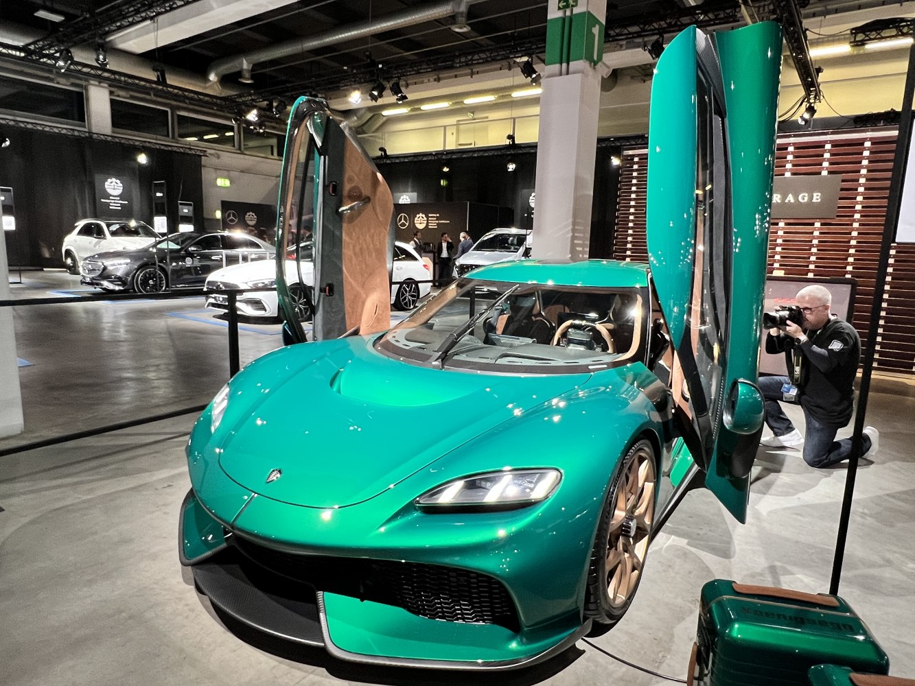 Green exterior with open butterfly doors and sleek aerodynamic design