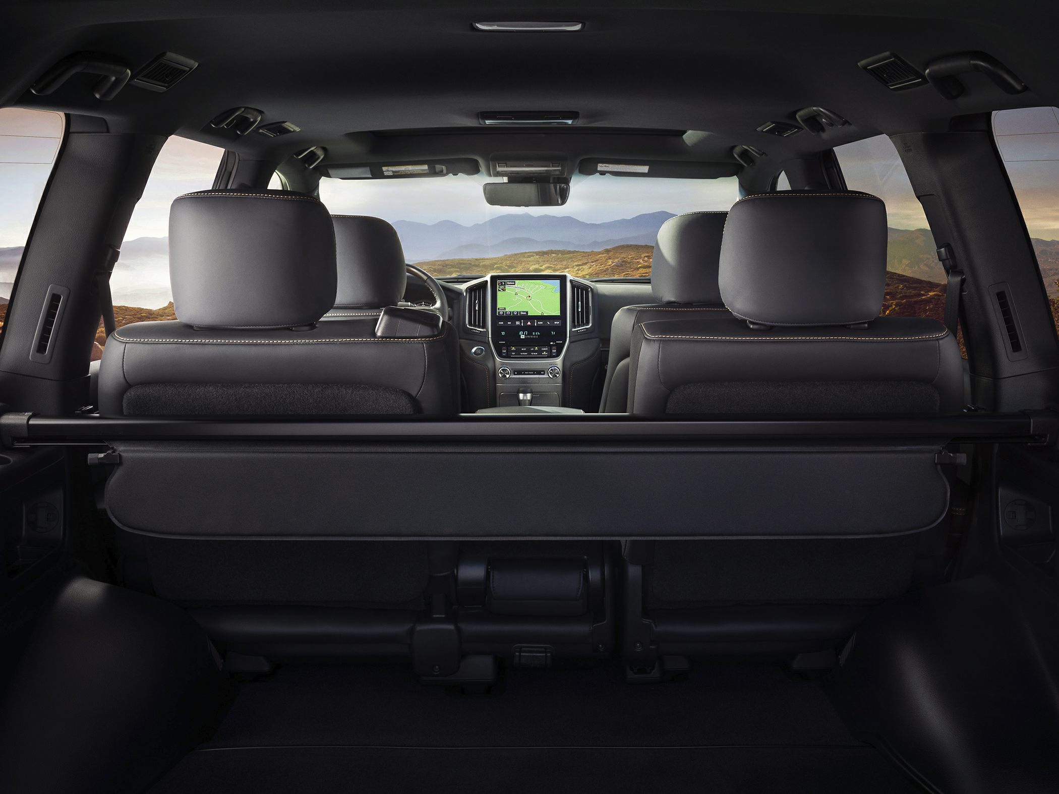 Rear interior view with front seats, dashboard, and navigation screen