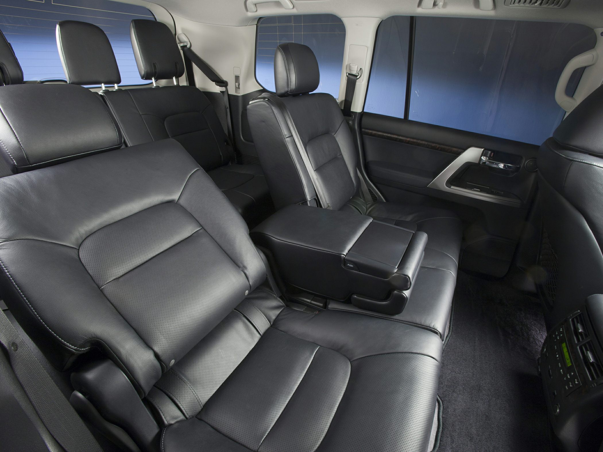 Black leather rear seating with armrest in spacious SUV interior