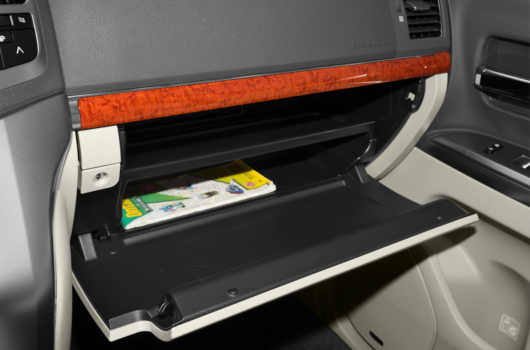 Open glove box with wood trim and storage compartment