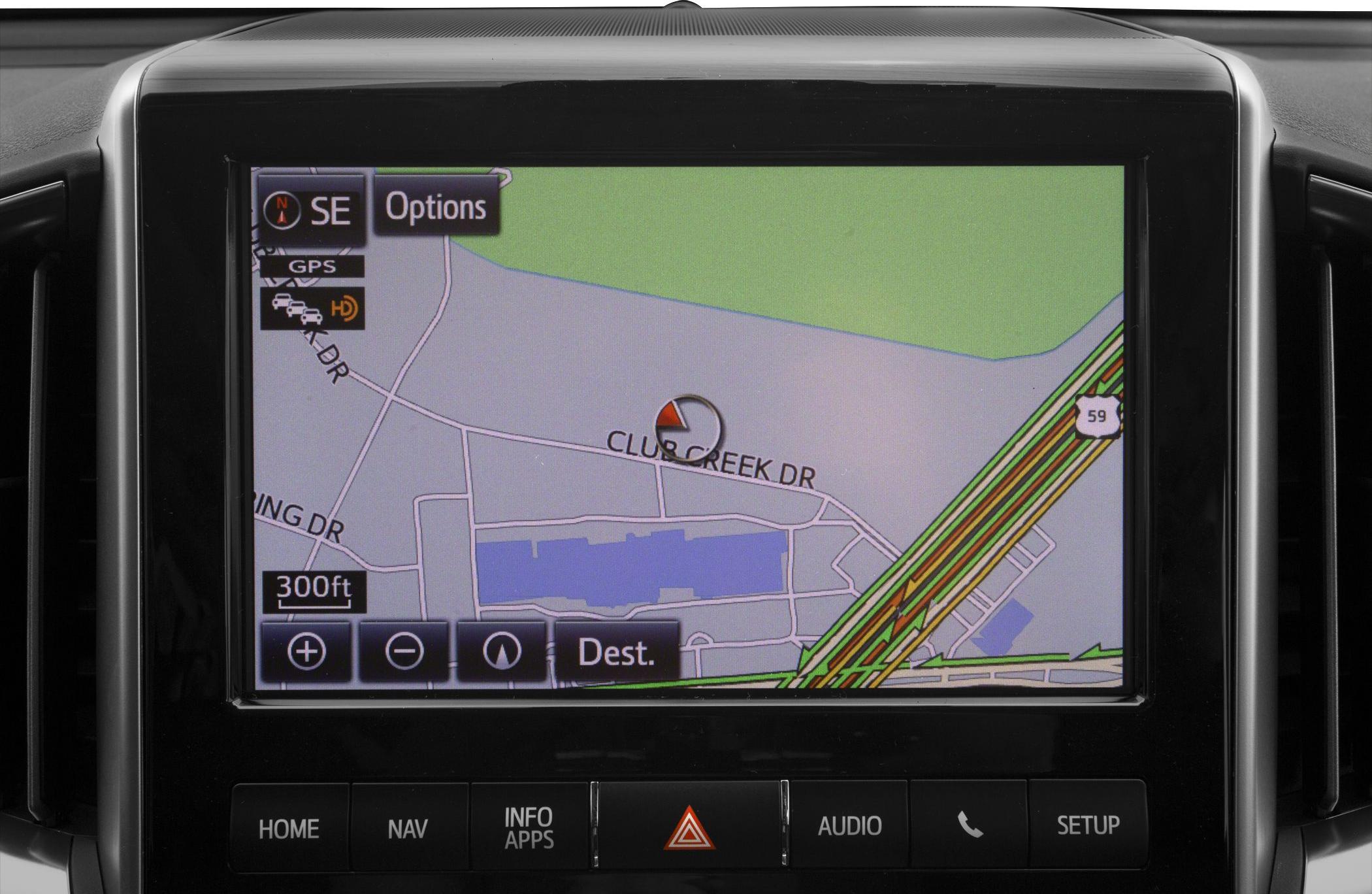 In-car GPS navigation screen with map and control buttons.