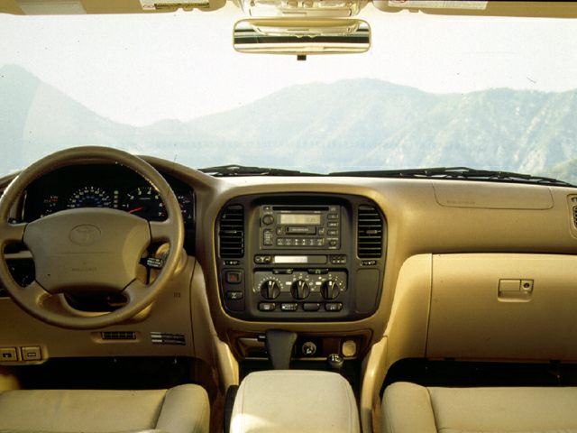 Beige dashboard and steering wheel with audio and climate controls