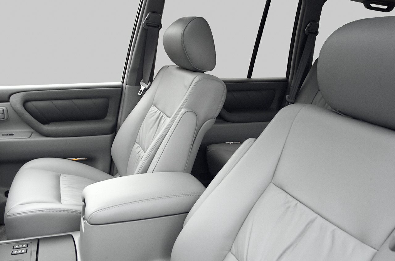 Leather front seats and door panels with integrated armrest and seatbelt