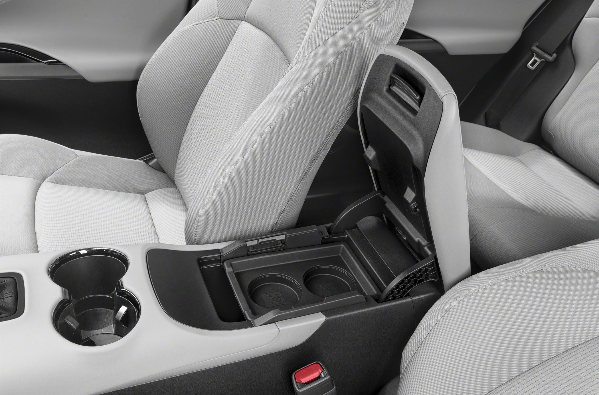 Center console with dual cup holders and storage compartment inside car interior