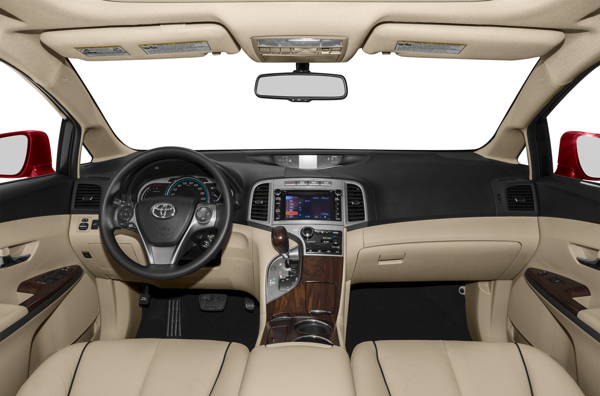 Dashboard, steering wheel, and center console with wood trim and beige upholstery