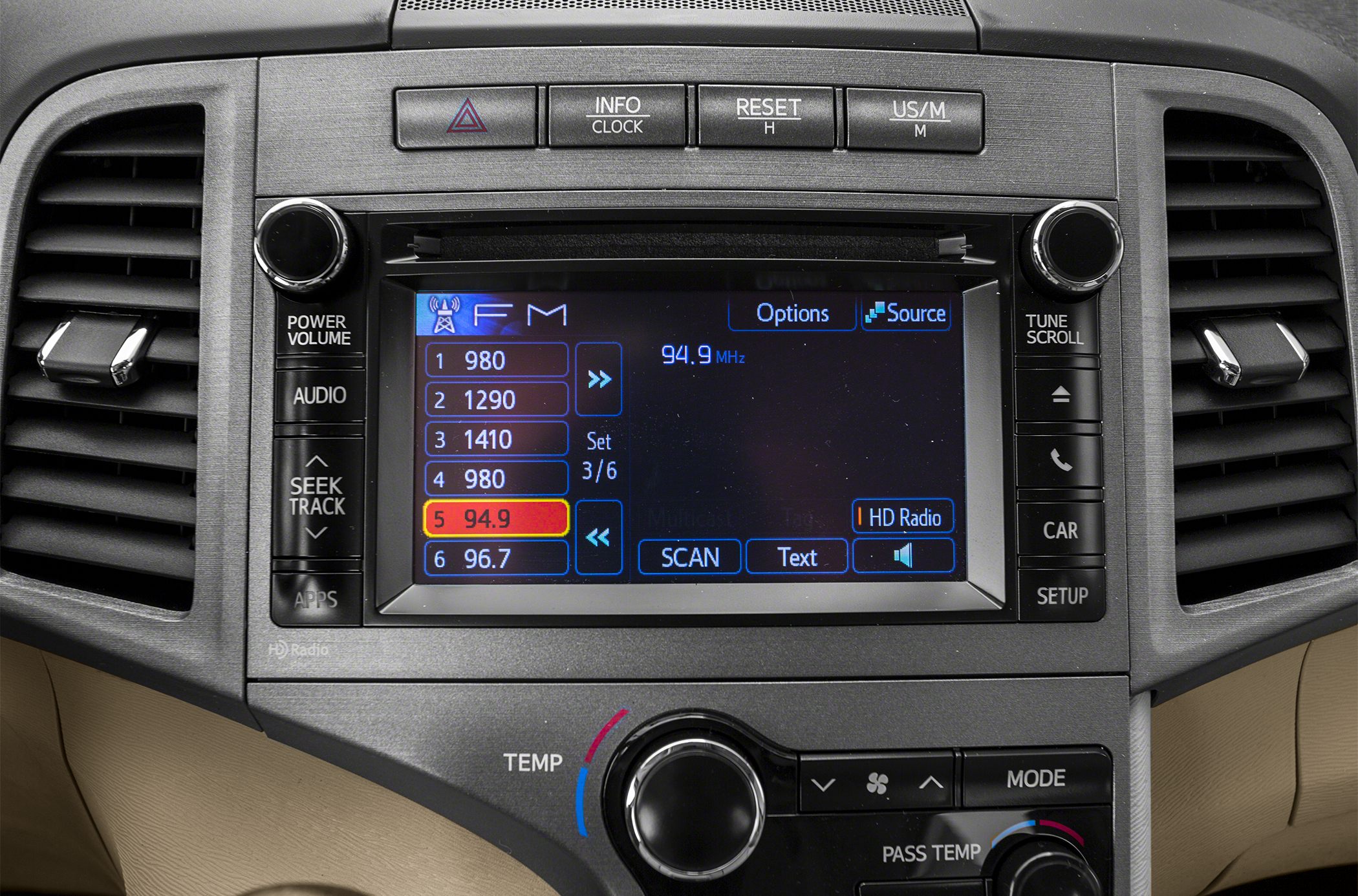 Dashboard infotainment system with FM radio and climate control knobs