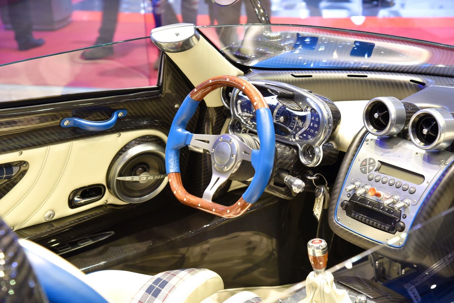 Wooden and blue leather steering wheel with unique dashboard and analog gauges