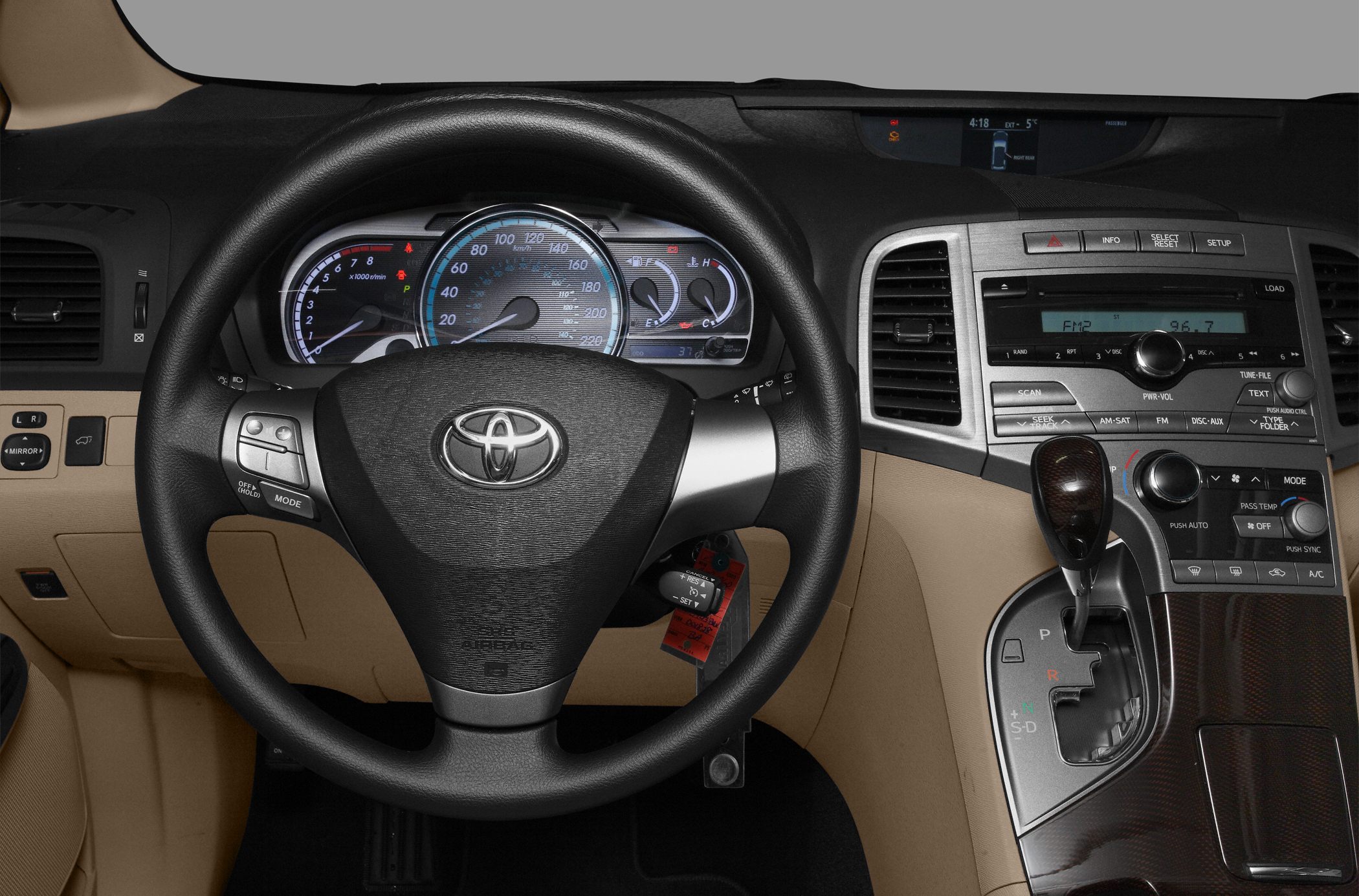 Dashboard instrument cluster, steering wheel, and gear shift lever in vehicle interior