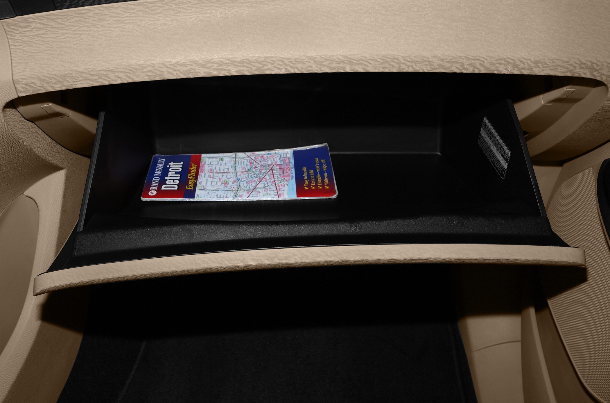 Open glove compartment with a paper map inside