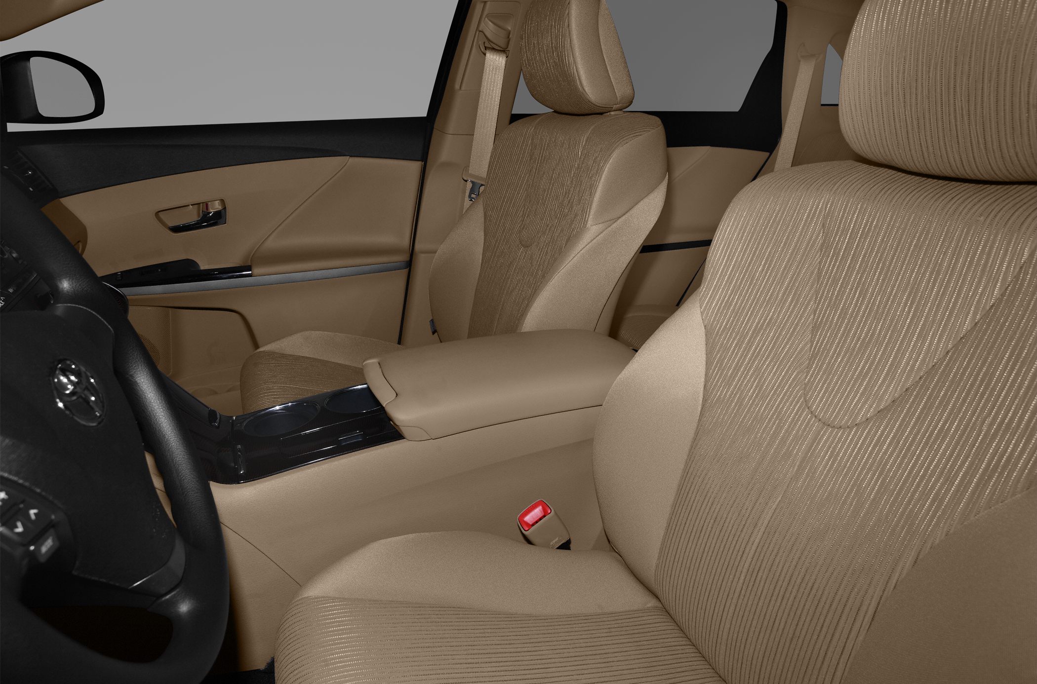 Beige fabric front seats with center console and seatbelt