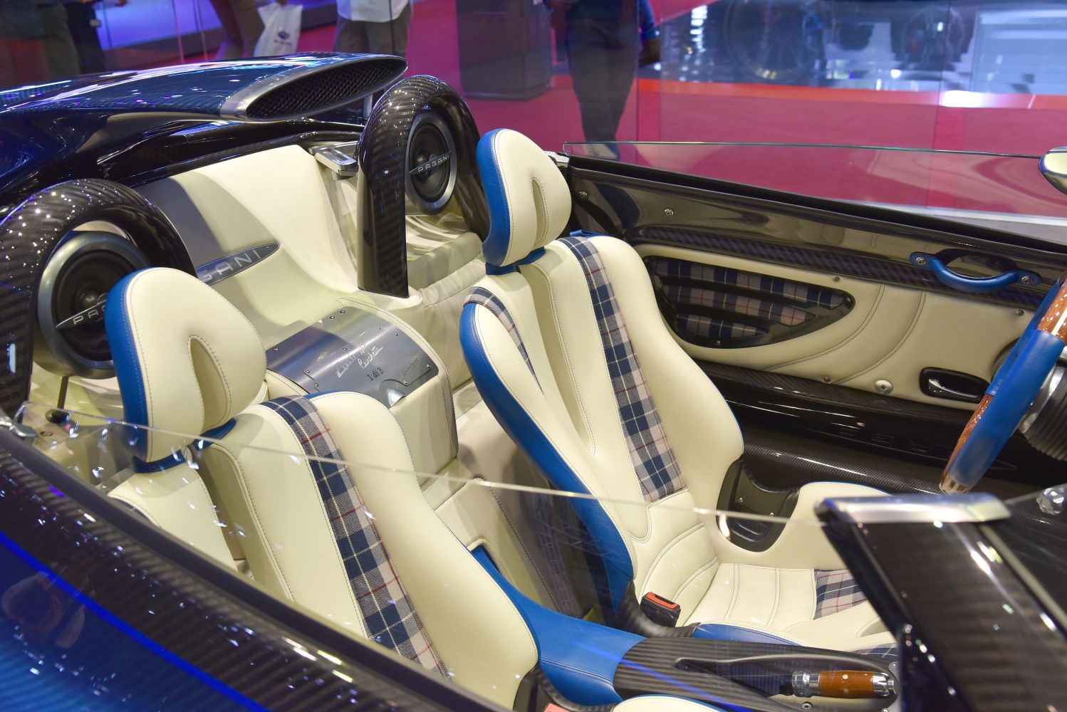 White and blue leather seats with plaid inserts in carbon fiber interior