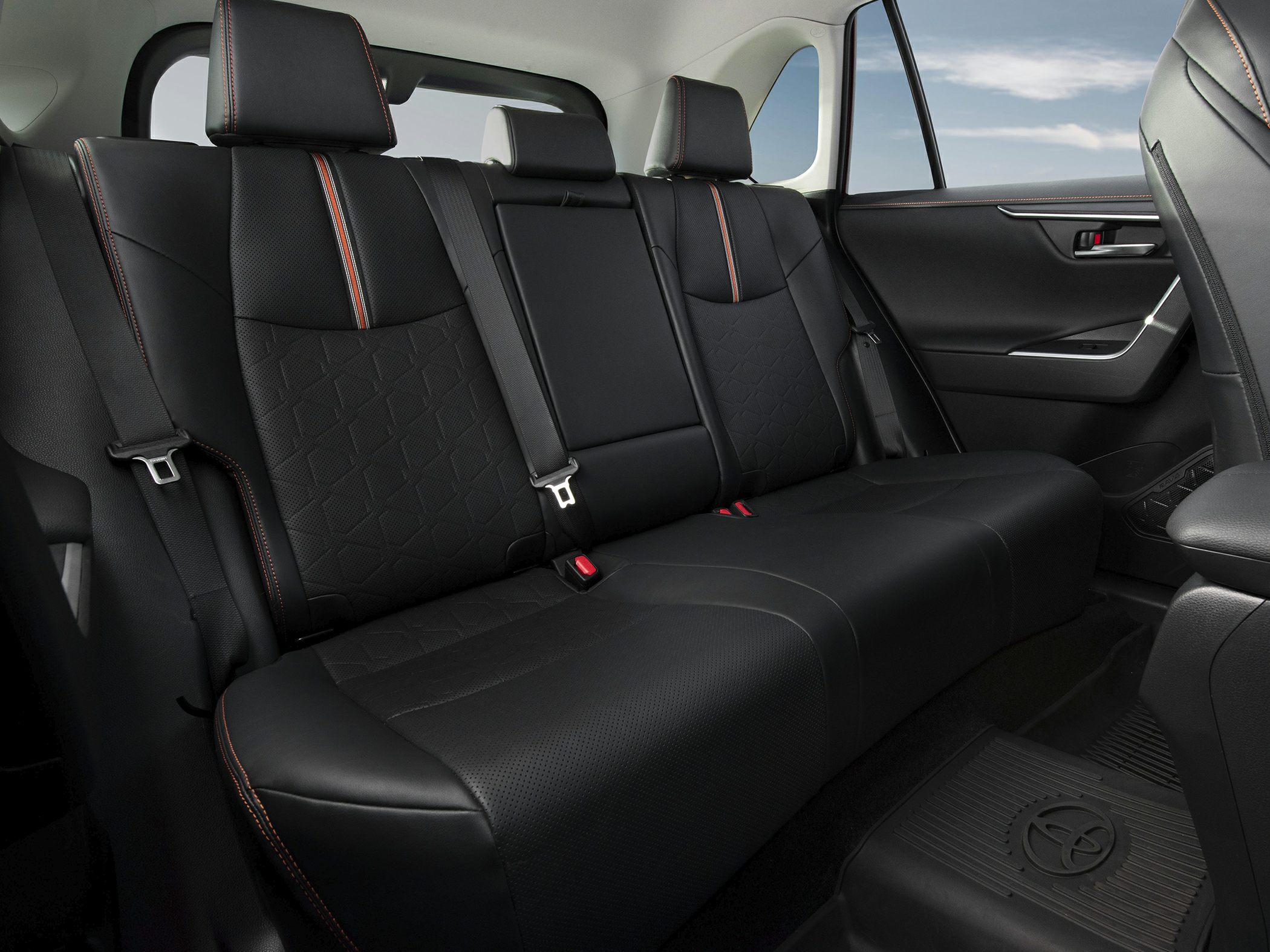 Black leather rear seats with orange stitching and seat belts