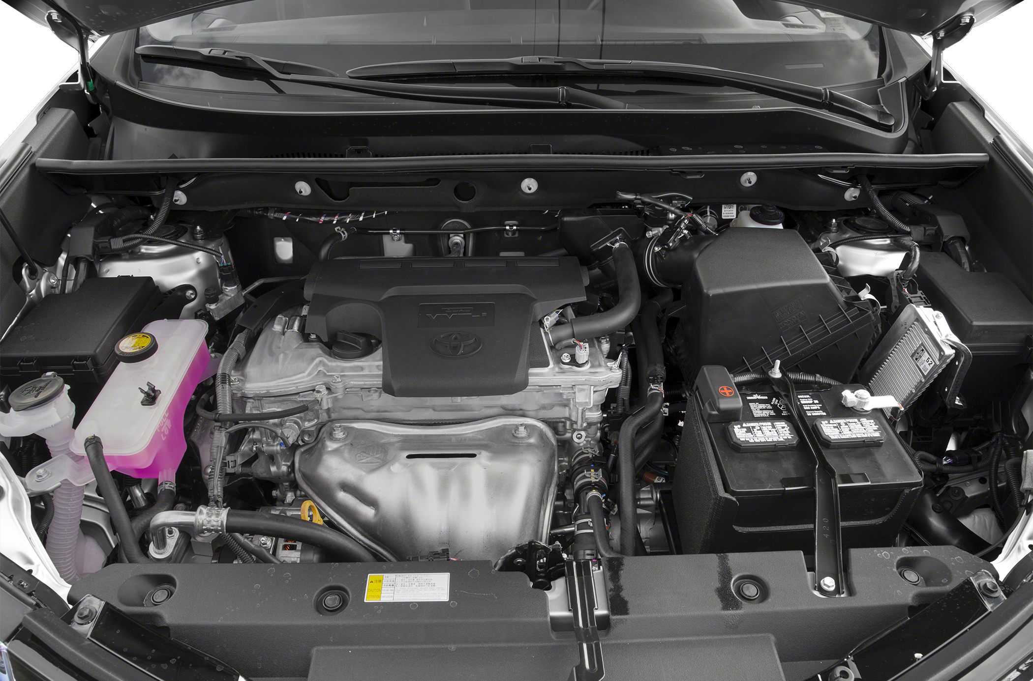 Engine bay with engine, battery, and coolant reservoir