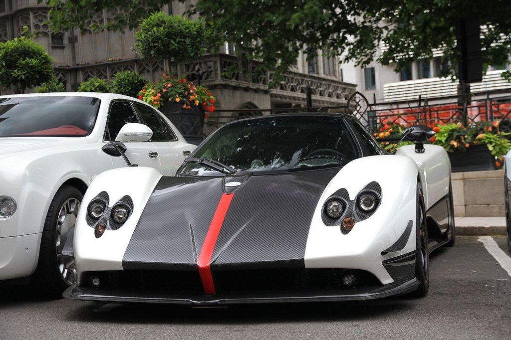 Front view of a sports car with carbon fiber hood and quad headlights