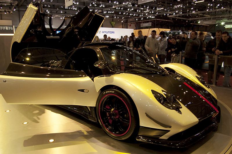 Open butterfly doors and carbon fiber hood with red stripe.