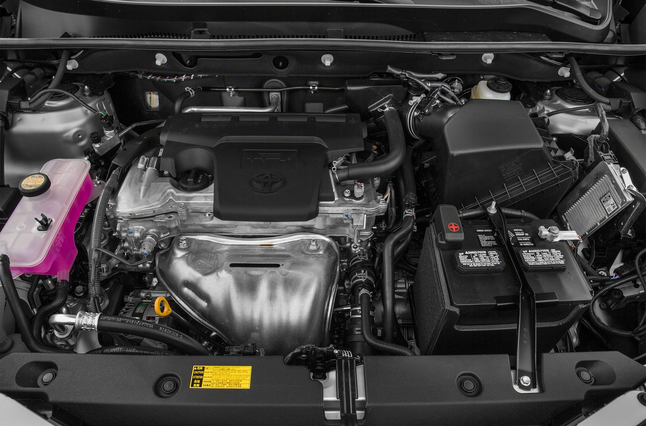 engine bay with battery, coolant reservoir, and intake hose