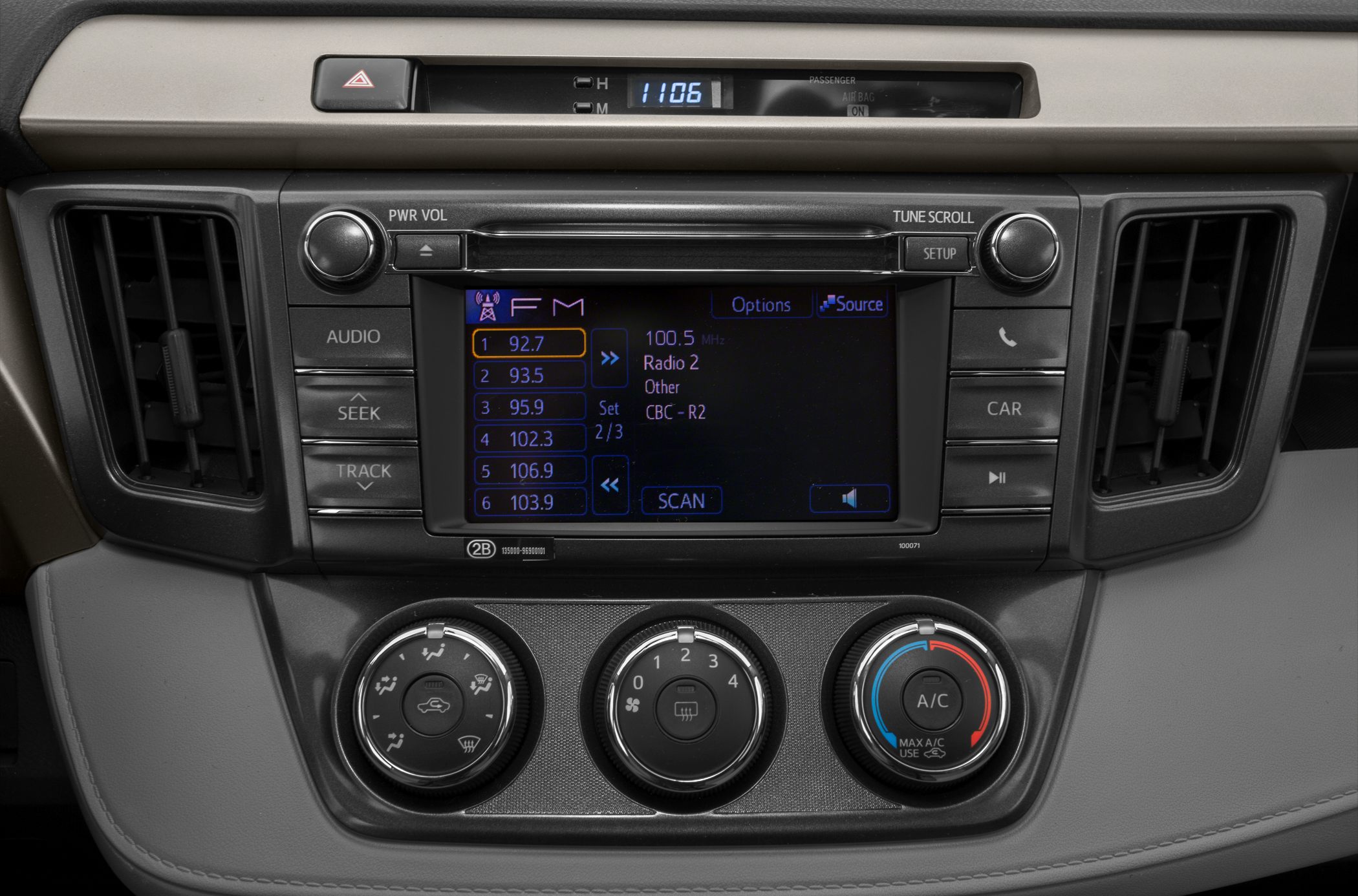 Car dashboard with audio system and climate control knobs