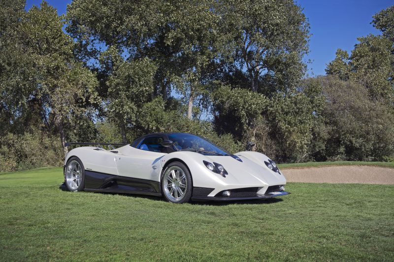White and black aerodynamic sports car with multi-spoke wheels and distinctive headlights